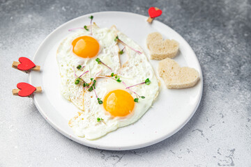 valentines day breakfast on the table scrambled eggs heart shape holiday decoration love date copy space food background