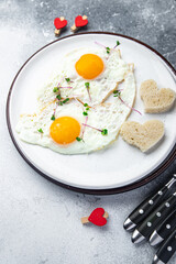 valentines day breakfast on the table scrambled eggs heart shape holiday decoration love date copy space food background
