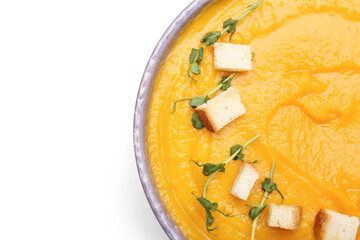 Bowl of tasty pumpkin cream soup on white background, closeup