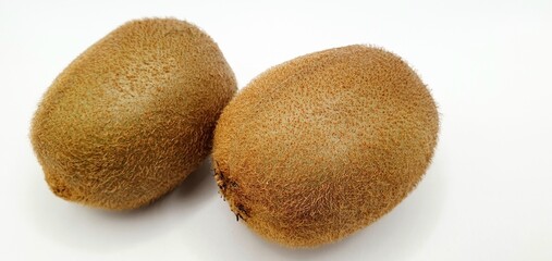 Two kiwi on a white background close-up. Ripe kiwi peeled on the table. Delicious kiwi fruit.