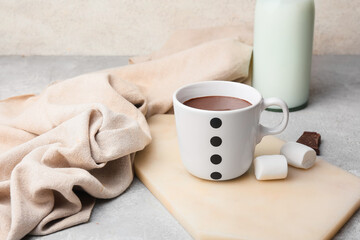Cup of natural hot chocolate with marshmallow on light background