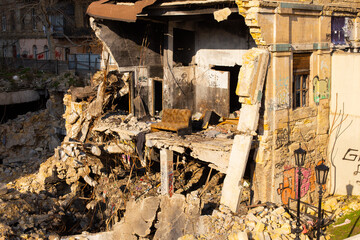 Ruined burnt down house with an old sofa in the rest of the room. Odessa city center, De Volan...