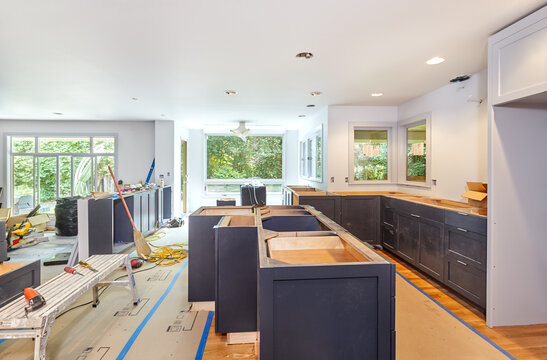 Installation of custom kitchen cabinets and island in progress