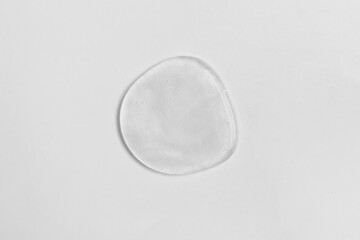 Drop of liquid transparent gel on white background