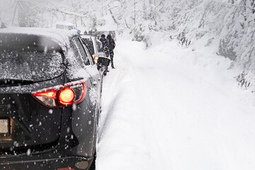 Russia, 4 january 2022. Traffic jam in heavy snowfall on mountain and forest road