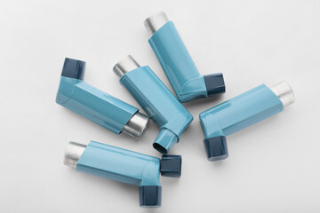 Asthma inhalers on white background