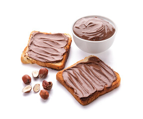 Bread with chocolate paste and hazelnuts on white background