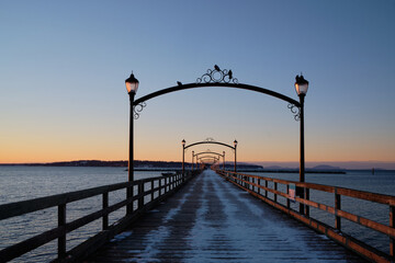 Fototapeta na wymiar White Rock's wooden pier - and birds. Day-break in winter.