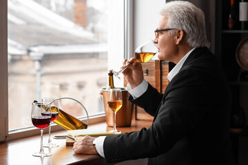 Mature sommelier tasting types of wine
