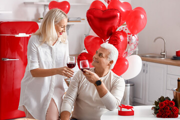 Happy mature couple celebrating Valentine's Day at home