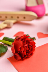 Beautiful red rose on pink background, closeup. Valentine's Day celebration