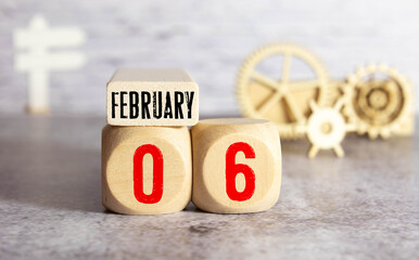 Vintage photo, February 6th. Date of 6 February on wooden cube calendar, copy space for text on board.