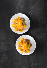 Italian cake, citrus Pandora with icing sugar on a plate on a dark gray background. Top view