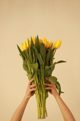 Bouquet of yellow tulips in hand