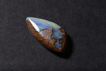 Colorful boulder opal gem from Winton Australia on black background