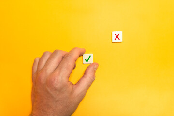 Right and Wrong Icon. Decision Making Concept. Block Letter Tiles on Yellow Background.