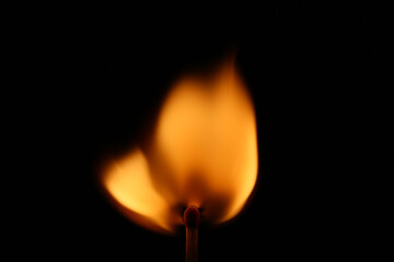 A match burned with an orange flame and produces heat 