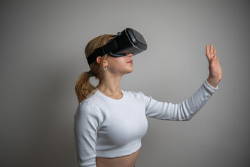 Woman wearing VR glasses and spending time controlling with joystick