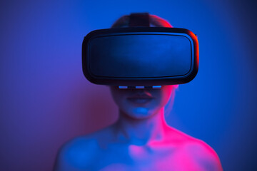 woman in white shirt wearing vr glasses, futuristic studio photo with colorful lights on plain...