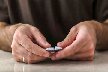 Tablet of pills in a man hands