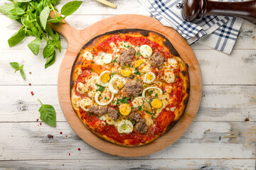 Pizza with tuna and cheese on wooden board top view on white wooden table