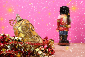 Christmas Ornaments and Christmas Nutcracker on Pink Background, Shallow DOF