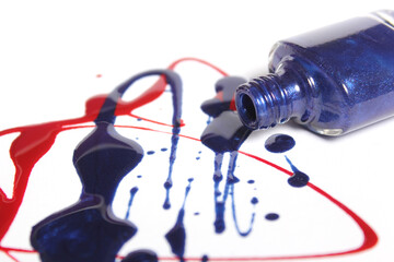 Naklejka premium Red and Blue Spilled Nail Polish on White Background