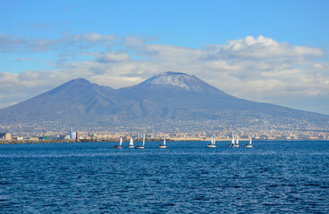 Gulf of Naples, mount Vesuvius and small sailboats in the blue sea