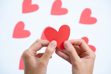 Obraz premium two hands holding one heart