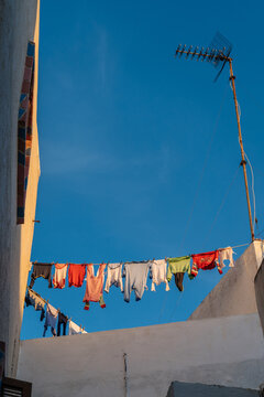 Multicolored linen on rope stretched between houses