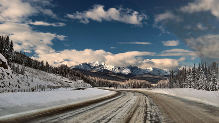Driving in the Canadian Rockies in winter on snowy road. Banff National Park. Alberta. Canada