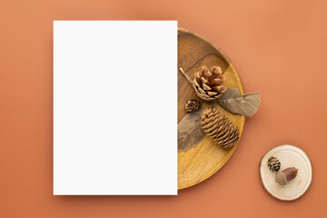 Autumn composition, Blank paper cards Mockup with dried leaves.  and pine cones on brown background. Flat lay, top view with copy space