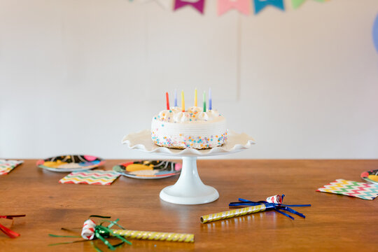 Birthday Cake on Stand and Party Accessories on Table