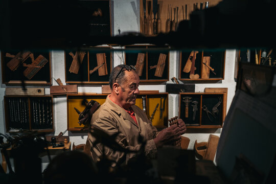 Carpenter with wooden detail in workshop