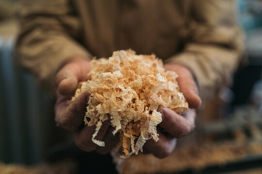 Handyman with handful of sawdust