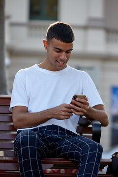 Young Indigenous Australian man using mobile phone outdoors