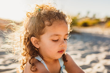 Young girl with long curls at beach