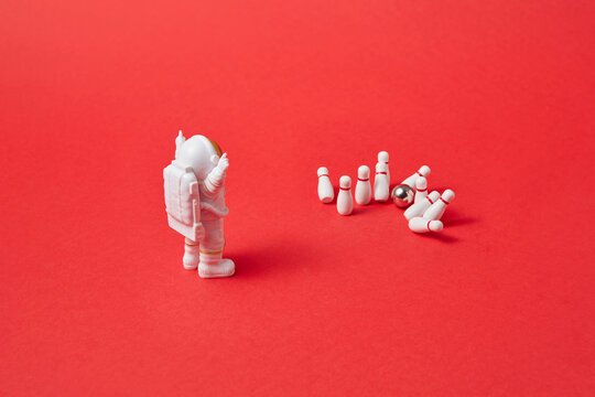 Cosmonaut making strike in bowling