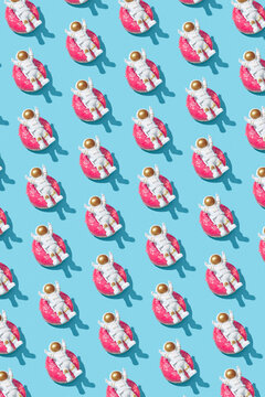 Rows of astronauts lying on donuts