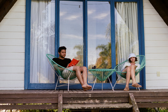 Couple Reading On A Porch