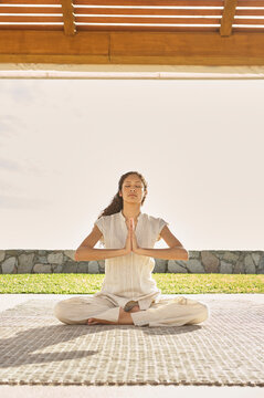 Woman doing yoga prayer pose at luxury spa