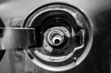 Open lid and removed gas cap of a vehicle ready to be fueled.