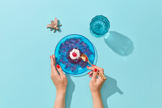 Crop woman eating gelatin dessert