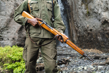 Unrecognizable man holding a weapon
