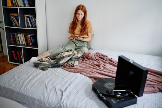 Beautiful girl listening songs and resting at home 