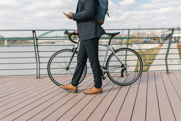 Black Man Pushing A Bike While Using His Phone