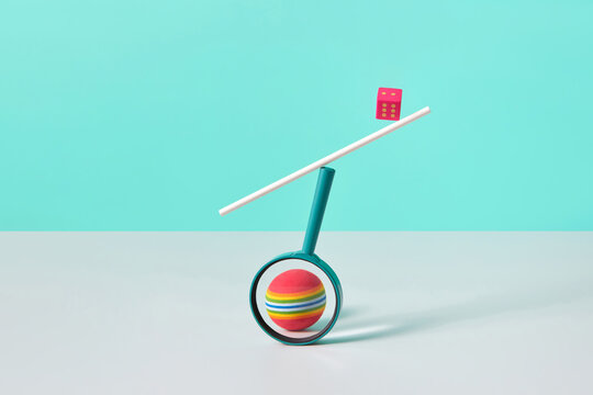 Dice balancing on magnifying glass