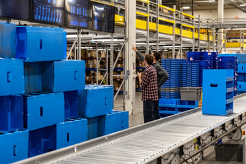 Manager meets with worker at modern Warehouse 