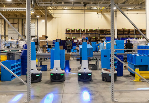 Employee Entering order information on multiple robots  