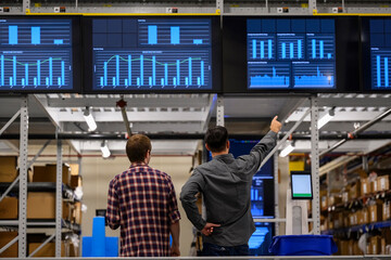 Manager meets with worker at E-Commerce Warehouse 